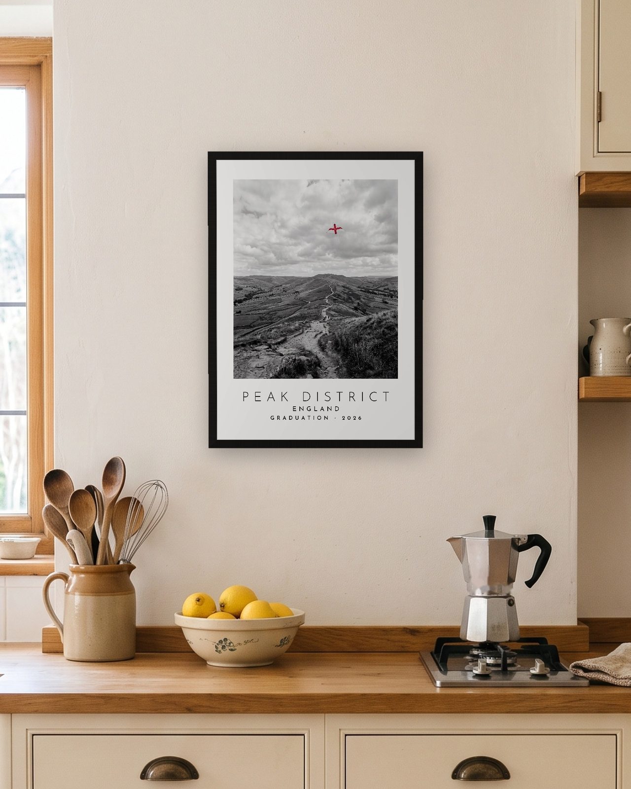 Our Trip Peak District print: black frame A3 in a bright kitchen, personalised GRADUATION · 2026