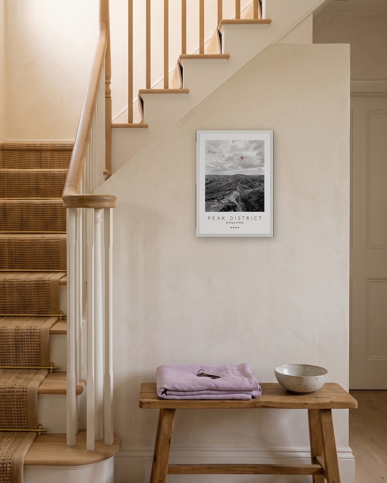 Our Trip Peak District print: white frame A3 on a staircase wall, personalised HOME