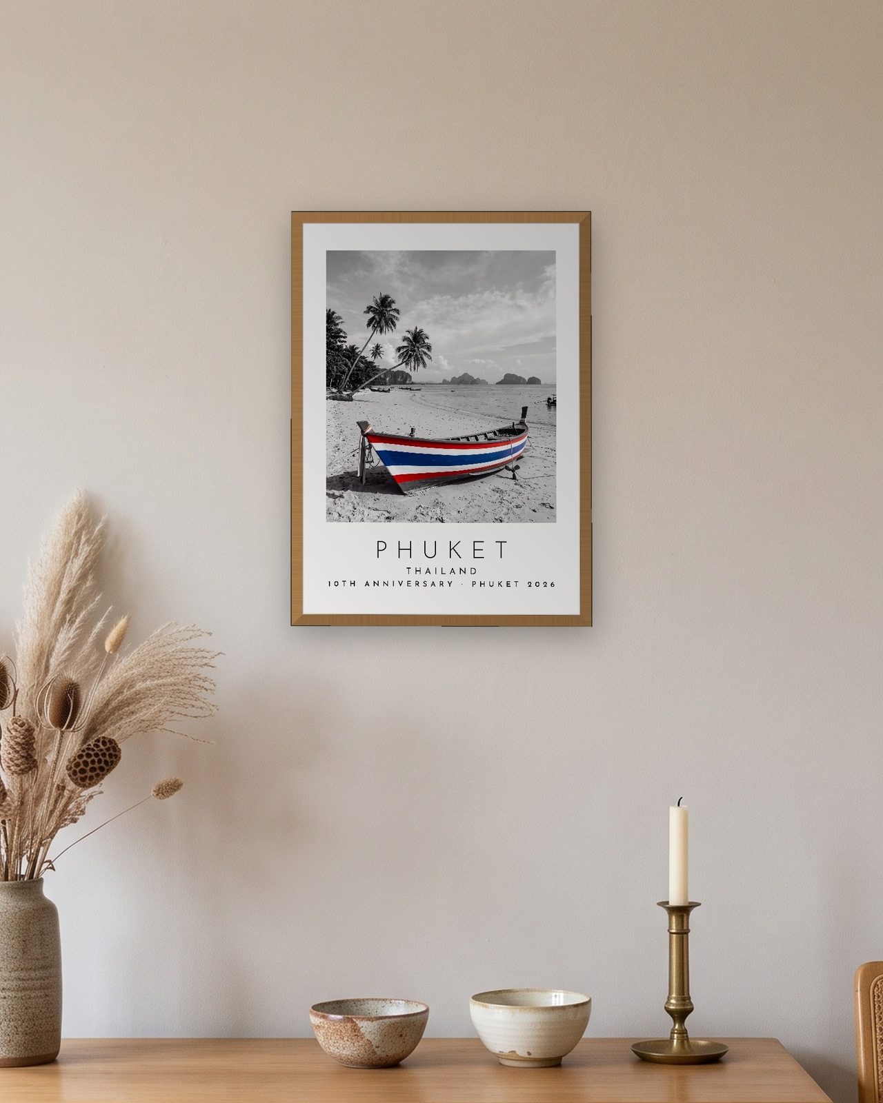 Our Trip Phuket print: natural oak frame A3 above an oak sideboard, personalised 10TH ANNIVERSARY · PHUKET 2026