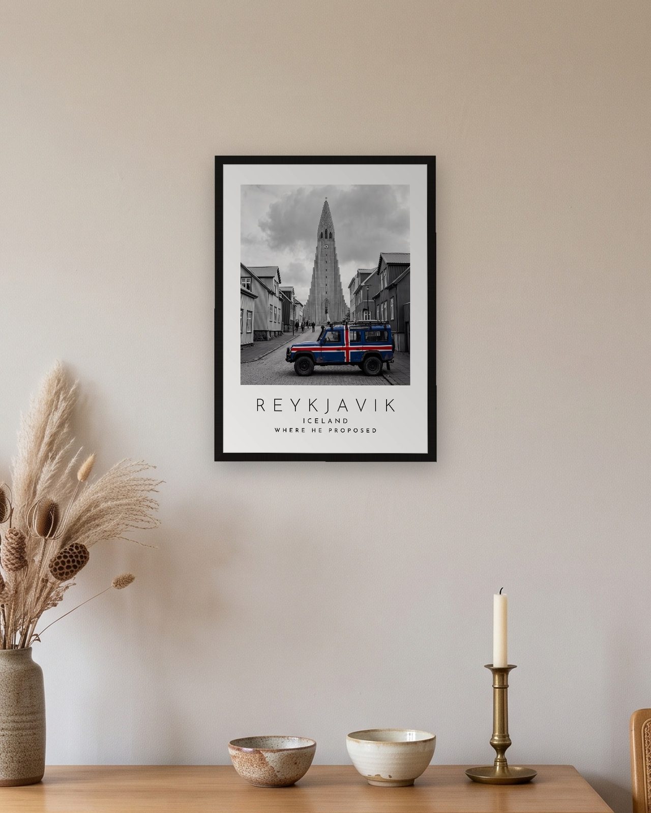 Our Trip Reykjavik print: black frame A3 above an oak sideboard, personalised WHERE HE PROPOSED