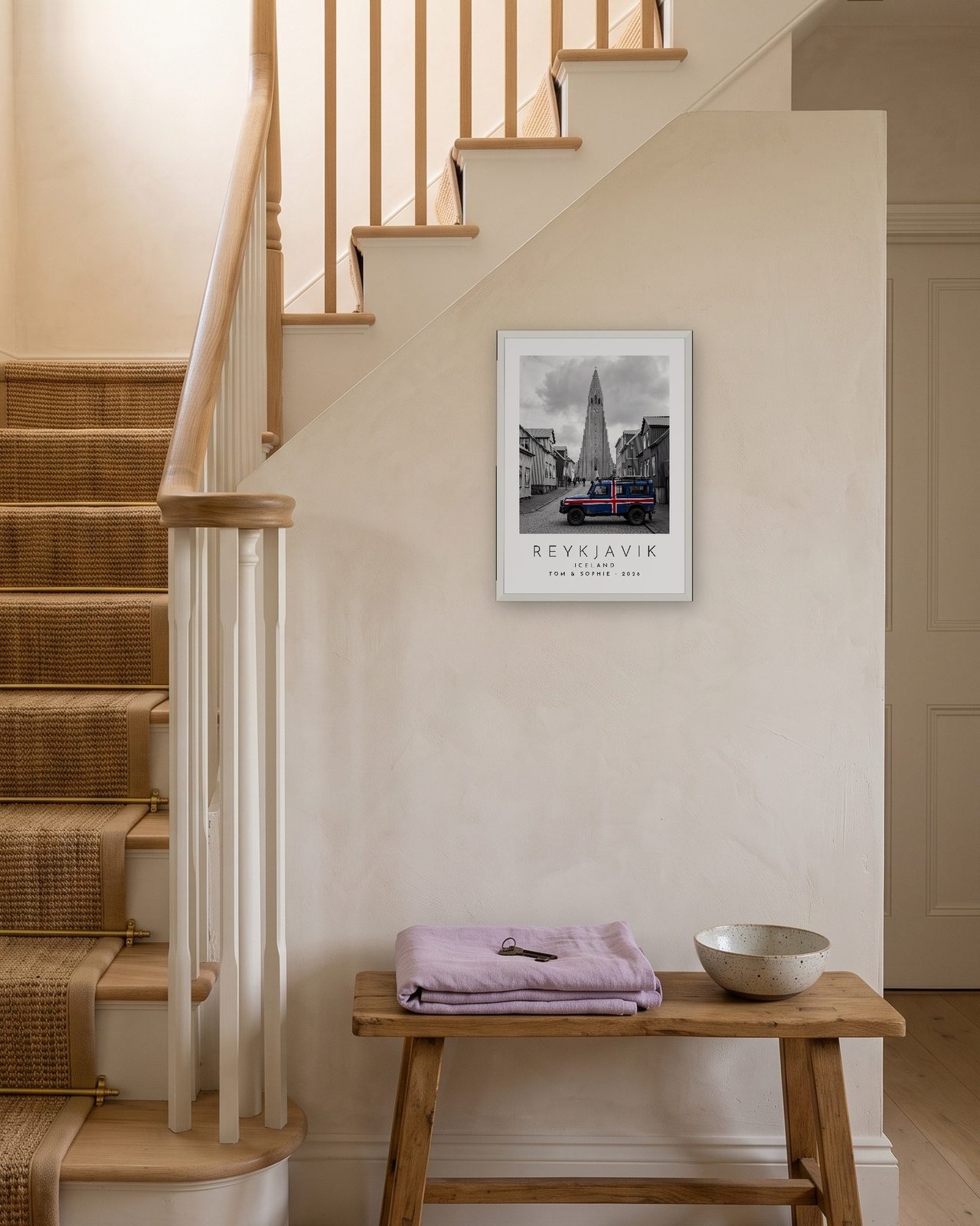 Our Trip Reykjavik print: white frame A3 on a staircase wall, personalised TOM & SOPHIE · 2026
