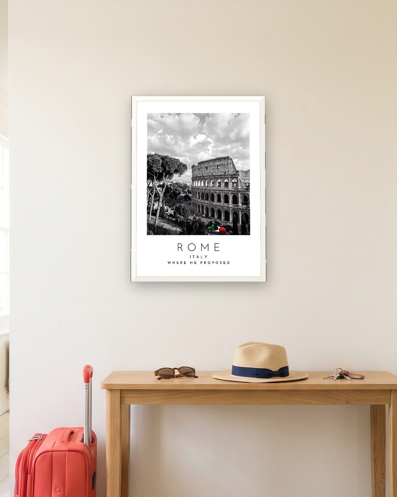 Our Trip Rome print: white frame A3 in a hallway with a packed suitcase, personalised WHERE HE PROPOSED