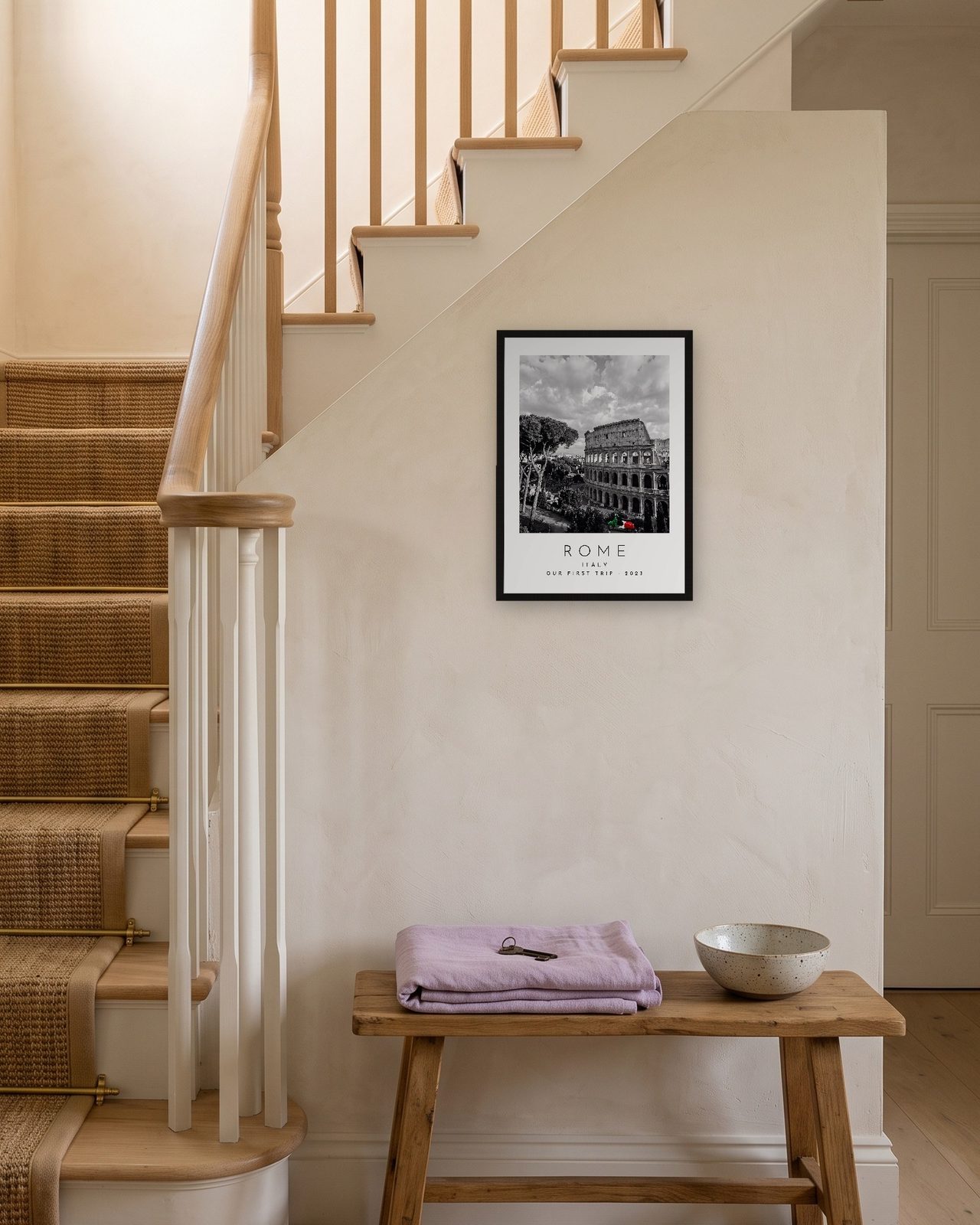 Our Trip Rome print: black frame A3 on a staircase wall, personalised OUR FIRST TRIP · 2023