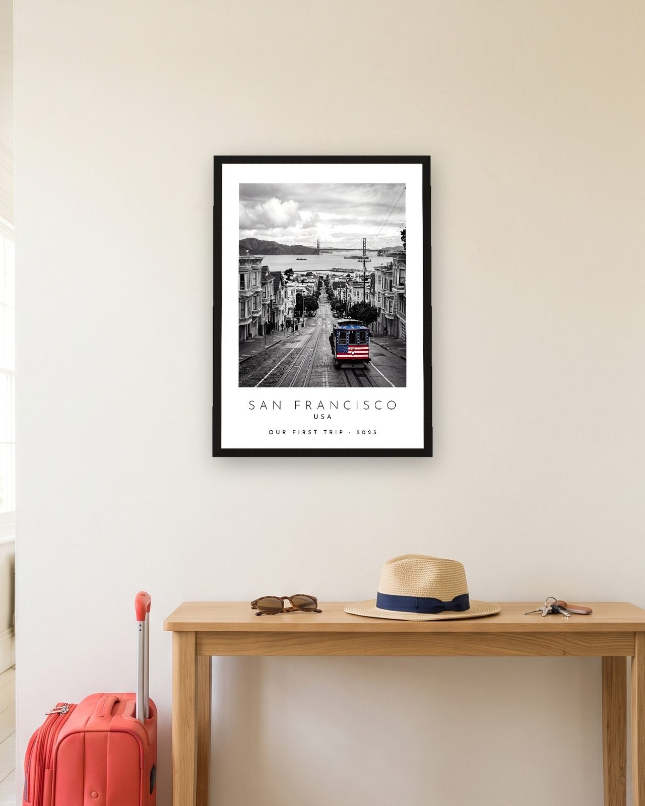 Our Trip San Francisco print: black frame A3 in a hallway with a packed suitcase, personalised OUR FIRST TRIP · 2023