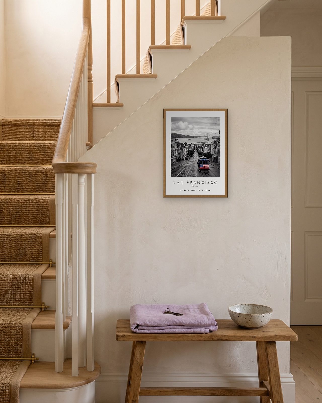 Our Trip San Francisco print: natural oak frame A3 on a staircase wall, personalised TOM & SOPHIE · 2026