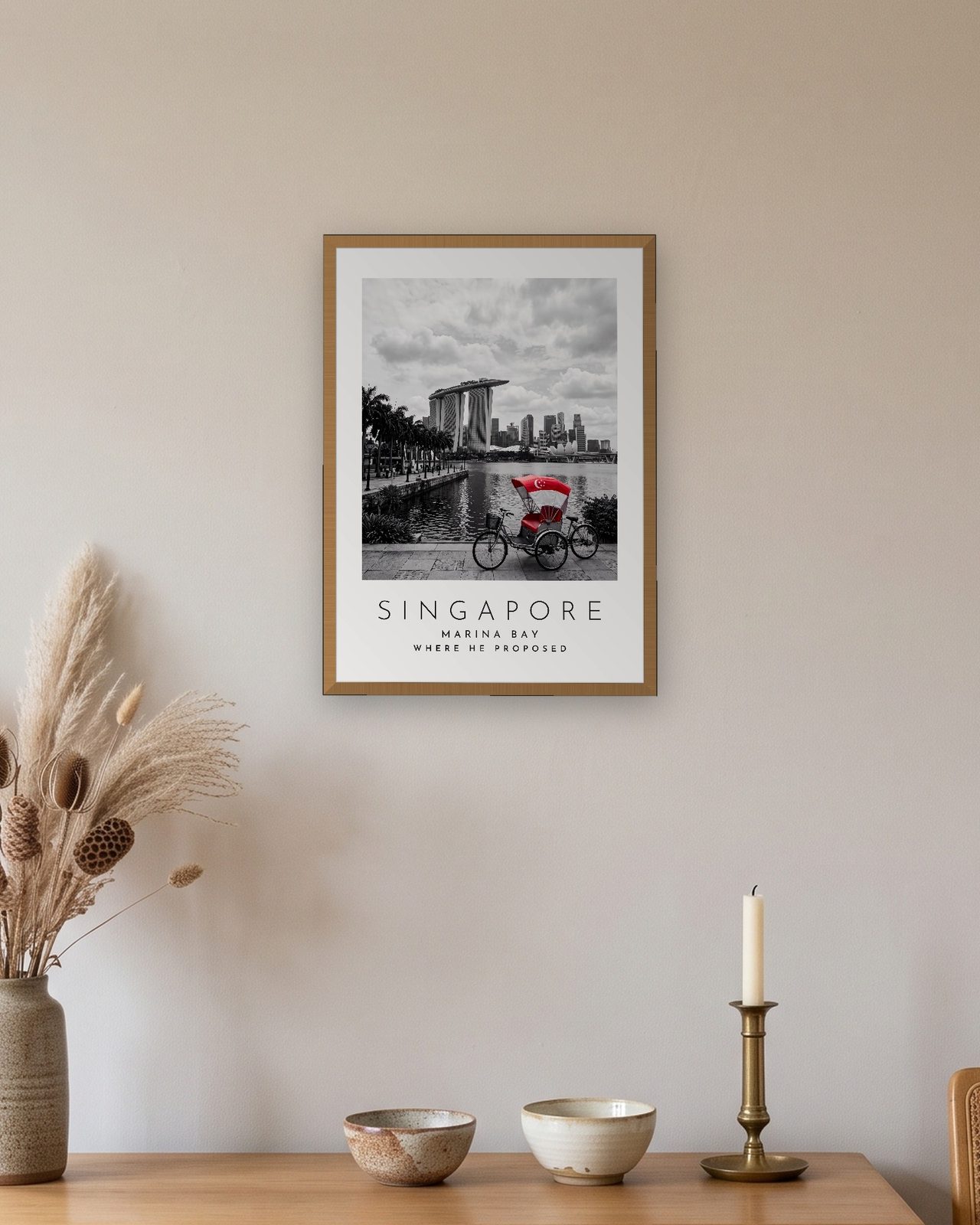 Our Trip Singapore print: natural oak frame A3 above an oak sideboard, personalised WHERE HE PROPOSED