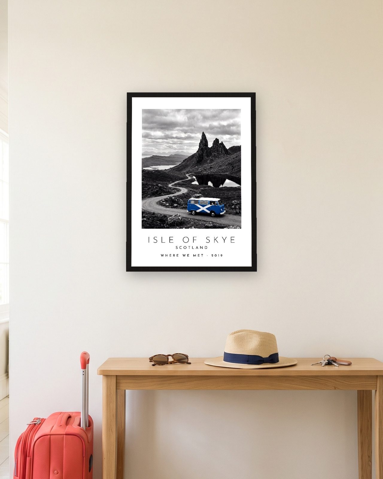 Our Trip Isle of Skye print: black frame A3 in a hallway with a packed suitcase, personalised WHERE WE MET · 2019