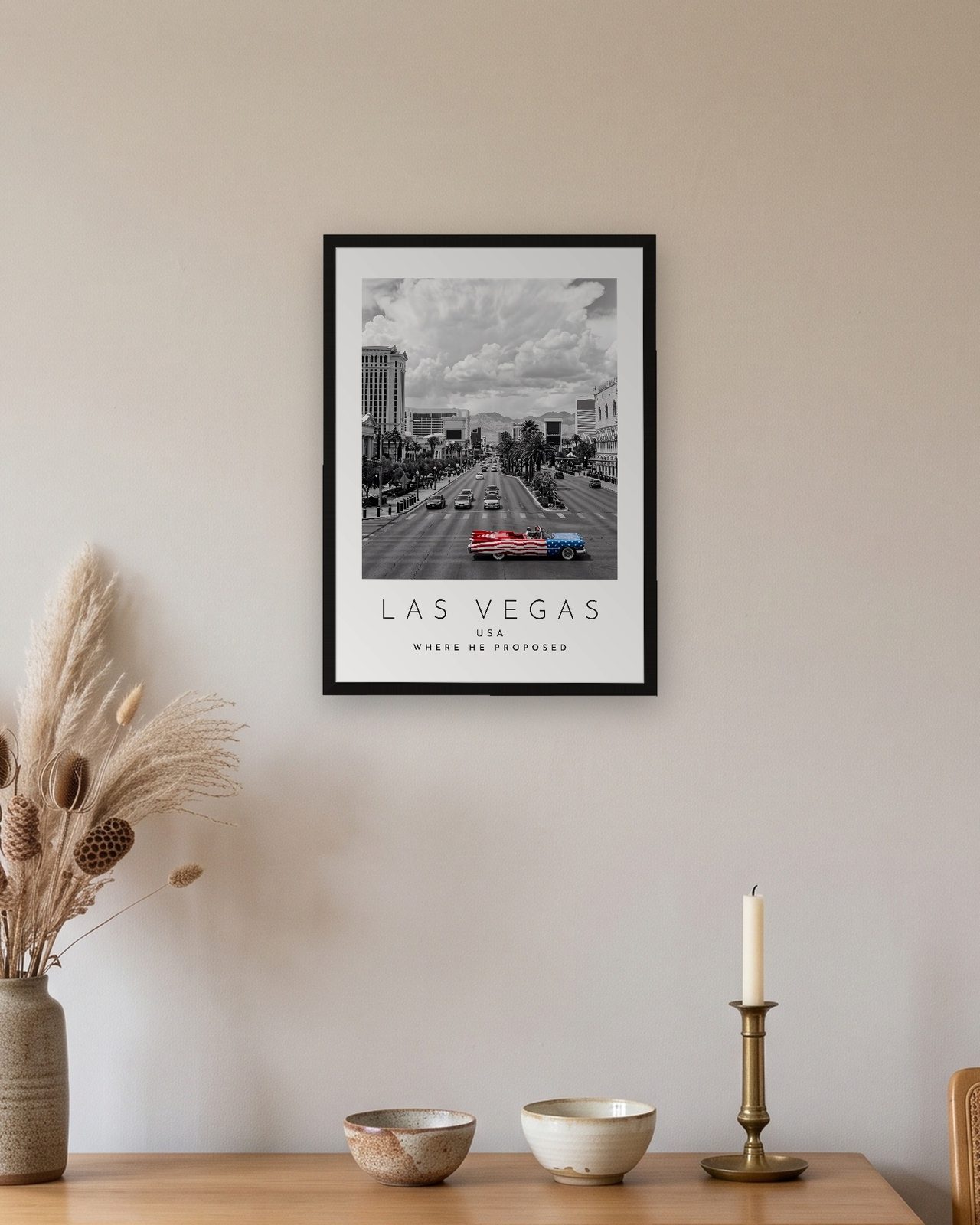 Our Trip Las Vegas print: black frame A3 above an oak sideboard, personalised WHERE HE PROPOSED