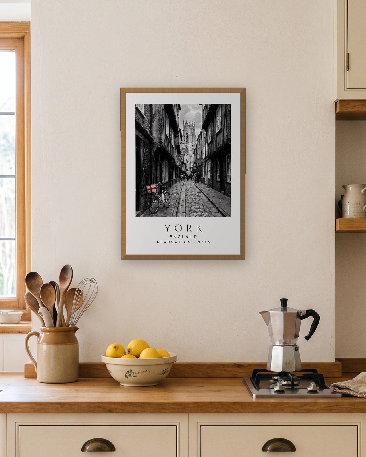 Our Trip York print: natural oak frame A3 in a bright kitchen, personalised GRADUATION · 2026