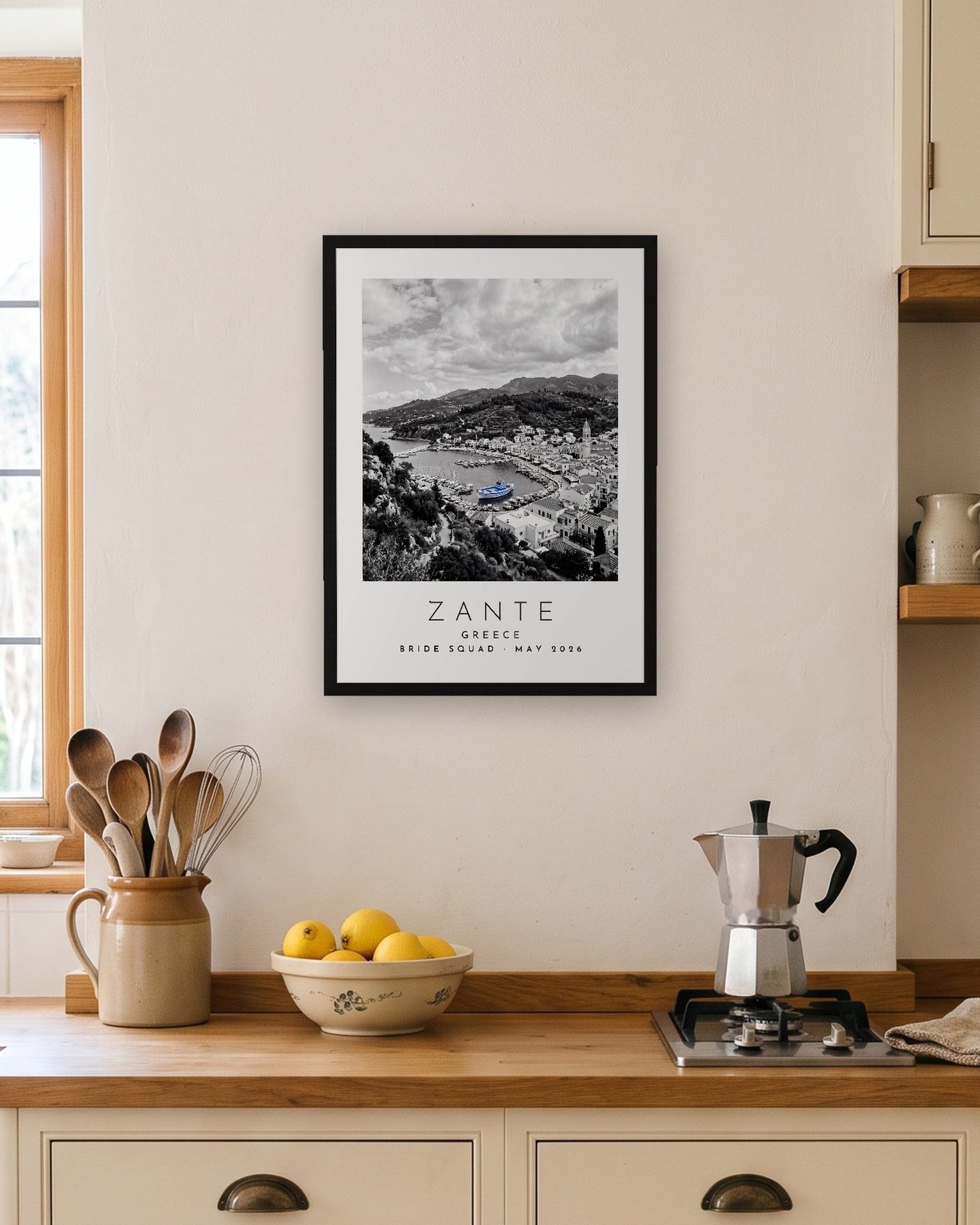 Our Trip Zante print: black frame A3 in a bright kitchen, personalised BRIDE SQUAD · MAY 2026