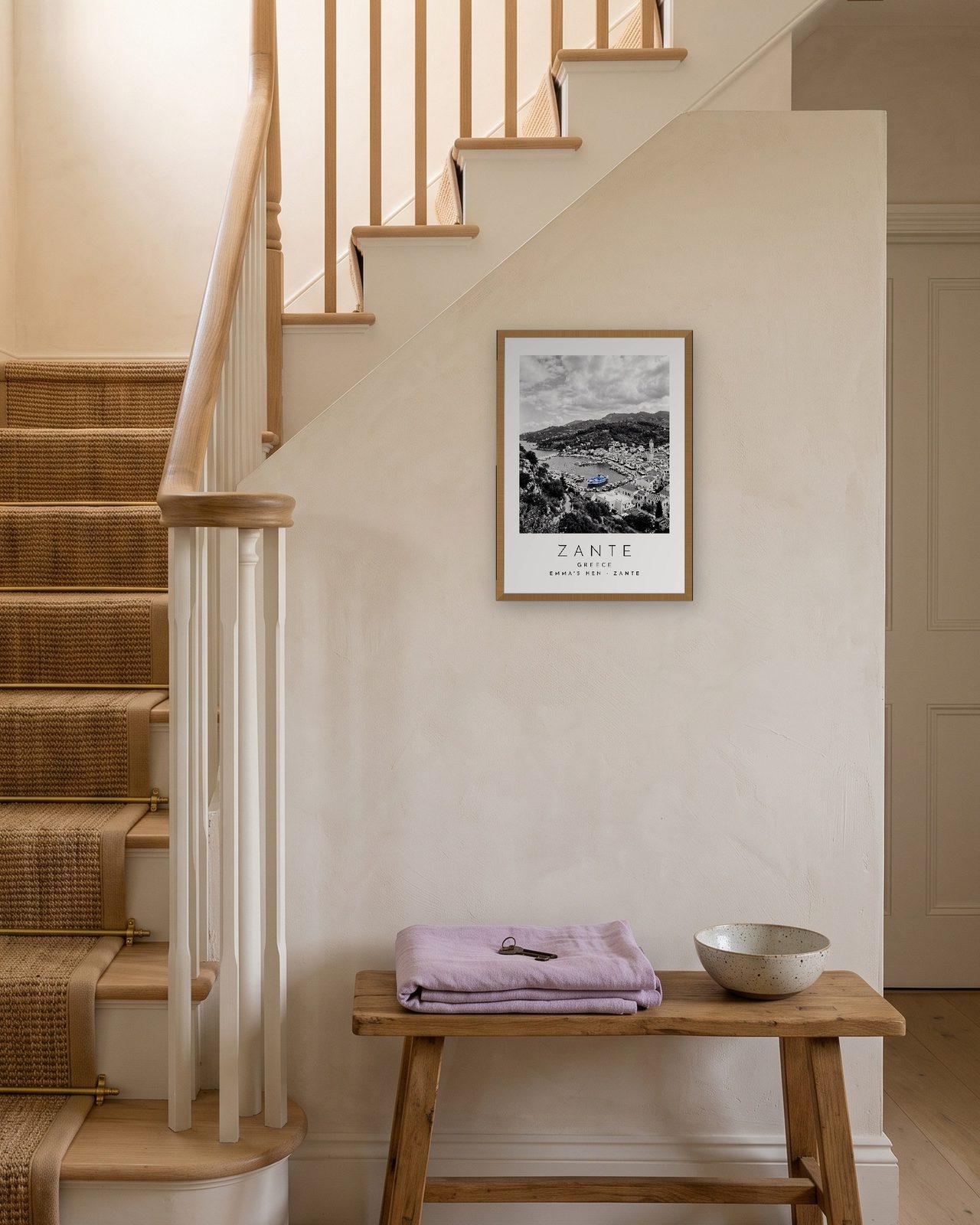 Our Trip Zante print: natural oak frame A3 on a staircase wall, personalised EMMA'S HEN · ZANTE